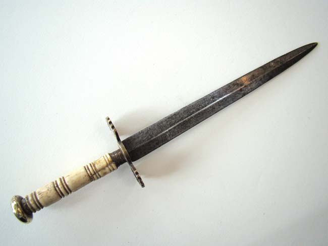 A Napoleonic Period British Naval Dirk with 8 1/2" engraved blade and original brass scabbard circa 1800-1820.